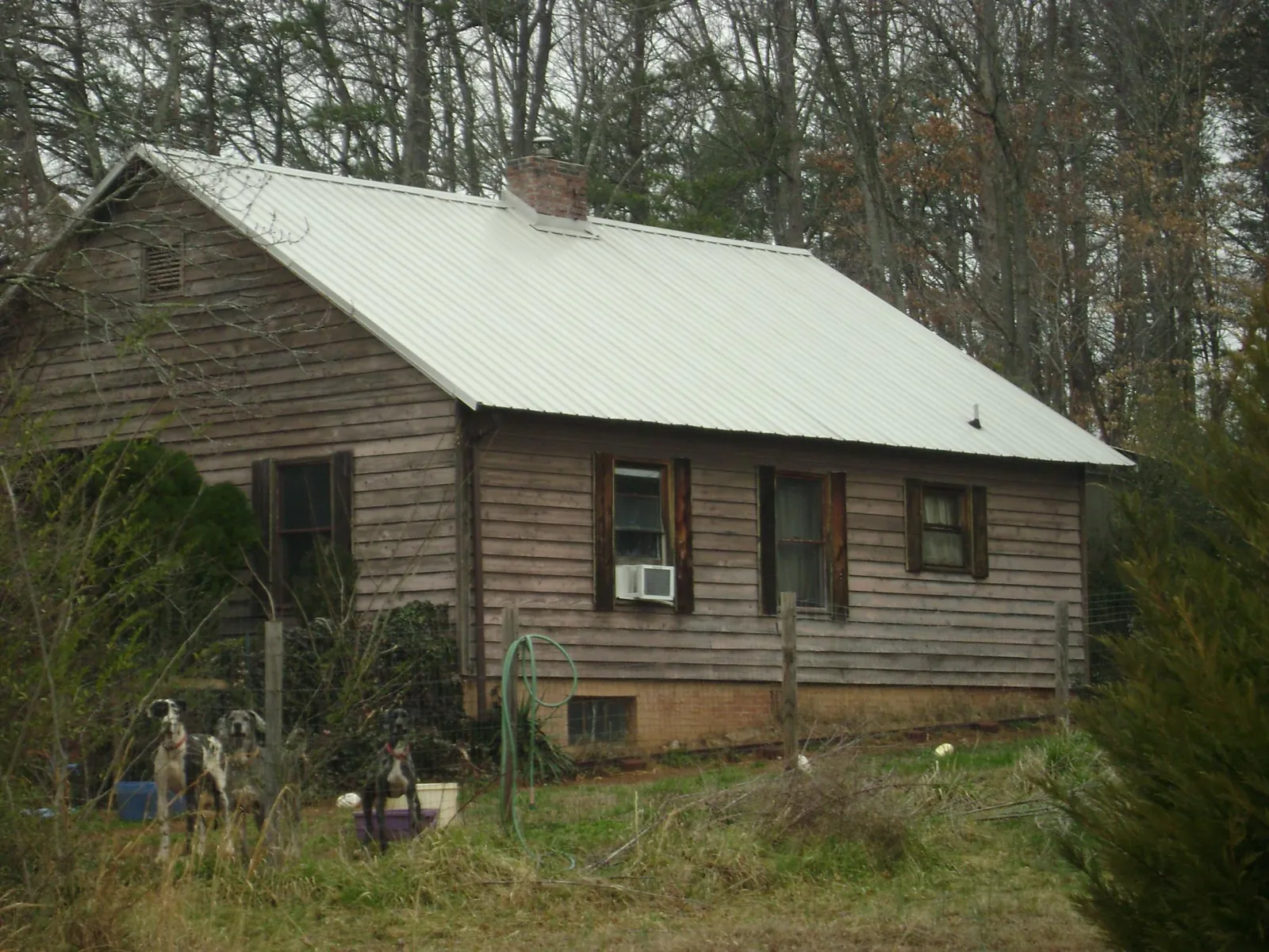 White metal roof on an old wood sided farmhouse, from a Metal Roof Installation job in Van Hornesville